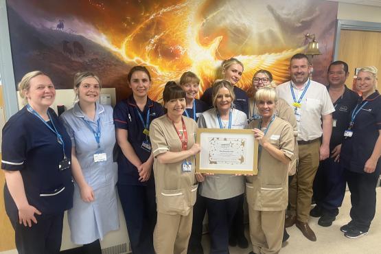 A group of people looking at the camera holding a certificate
