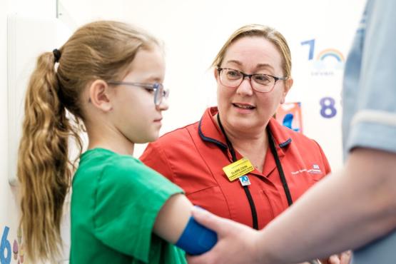 A nurse talking to a young patient