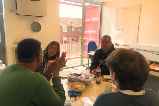 A group of people sitting round a table