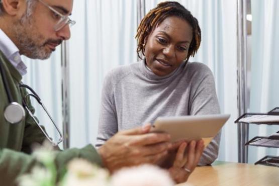 A doctor talking to a patient in his surgery practice