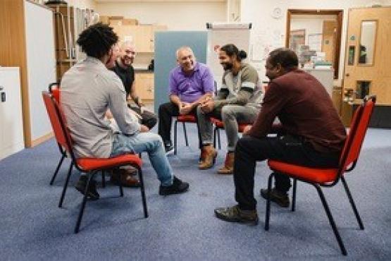 Men chatting in a mental health support group