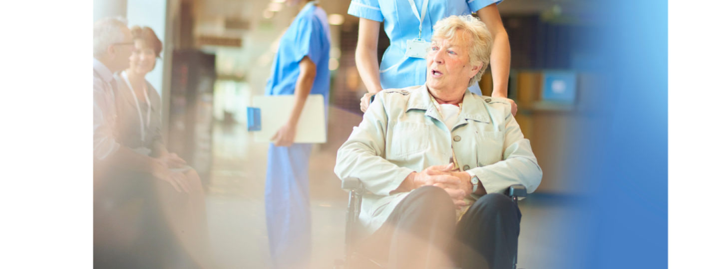 Woman in a wheelchair talking to a nurse
