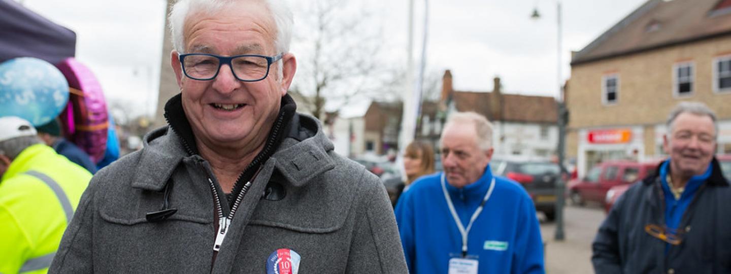 Man at a Healthwatch event smiling at the camera