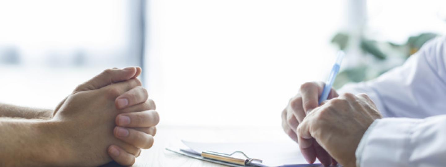 Two people speaking over a desk