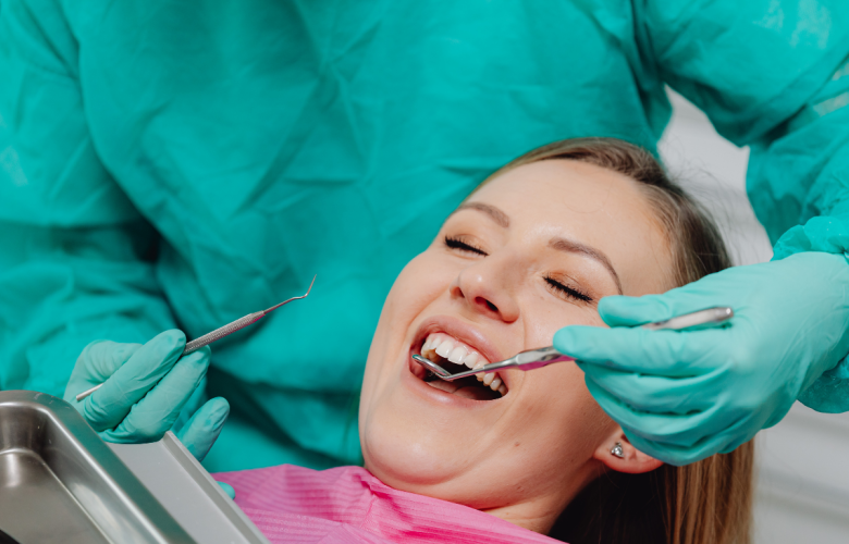 A lady having her teeth checked by a dentist